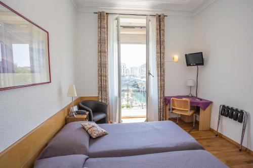 Postel nebo postele na pokoji v ubytování Hotel des Tourelles