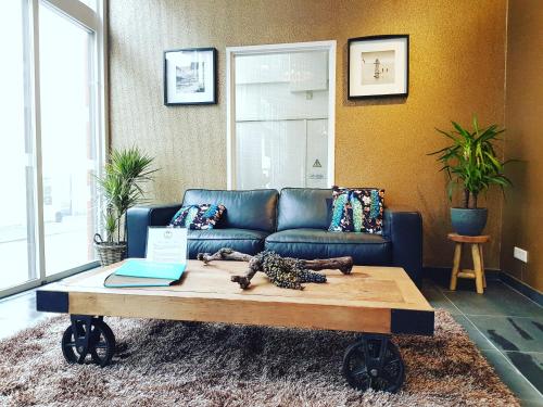 a living room with a couch and a coffee table at Hotel Zilt in Vlissingen