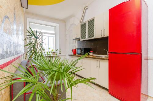 a red refrigerator in a kitchen with plants at Хостел 17 in Kyiv