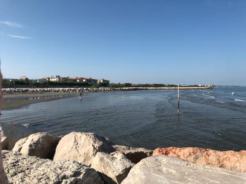 a view of a beach with rocks and the water at Appartamento Alla Riviera in Venice-Lido