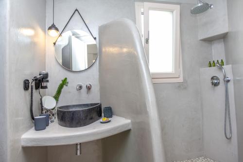 a bathroom with a sink and a mirror at Emery Hotel in Naxos Chora