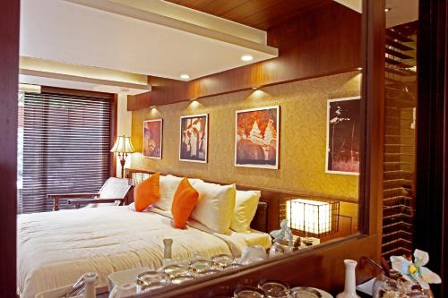 a bedroom with a large bed and a mirror at Vgp Golden Beach Resort in Chennai