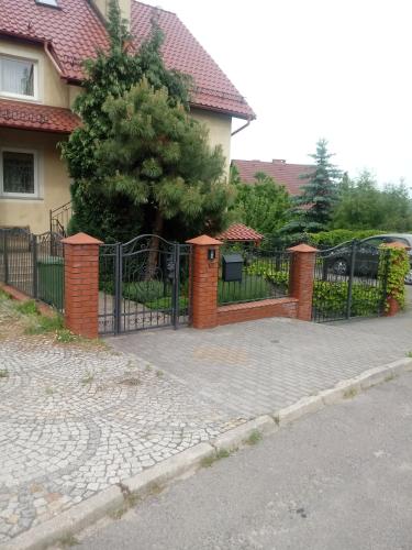 a wrought iron gate in front of a house at villa in Nowa Ruda