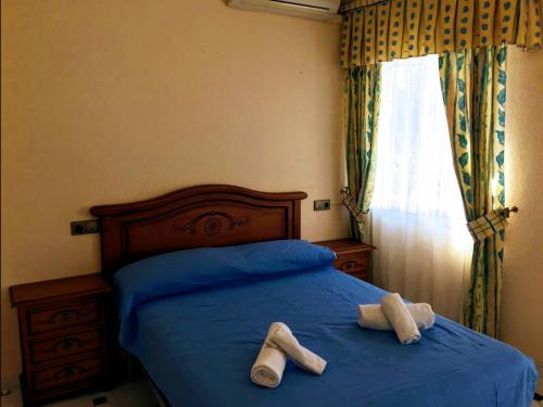 Giường trong phòng chung tại Villa Adela