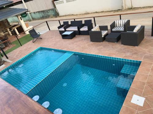 an overhead view of a swimming pool with couches and chairs at Aussieland Bungalows in Lamai