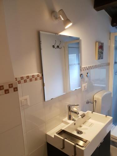 a bathroom with a sink and a mirror at La casa di "Bella" in Milazzo