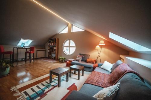 a living room with two couches in a attic at Casa Agnese in Alba