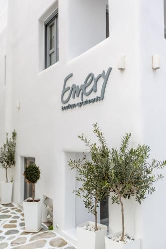 a group of potted trees in front of a building at Emery Hotel in Naxos Chora
