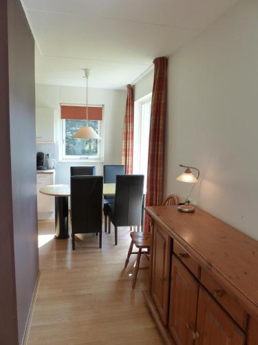 a kitchen and dining room with a table and chairs at Noordwijk Holiday Rentals in Noordwijk