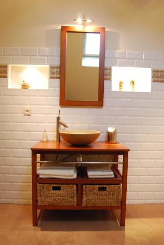 a bathroom with a sink and a mirror at Le Clos des Roys in Reims