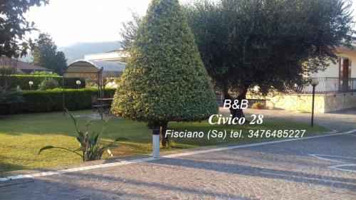 a sign in front of a tree on a street at B&B Civico 28 in Mercato San Severino