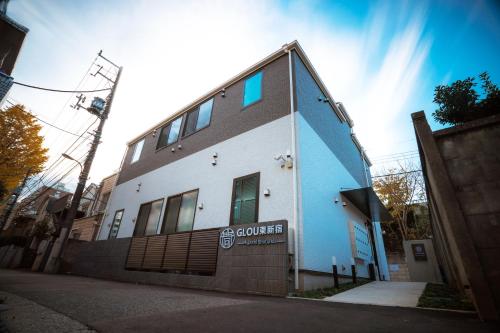 a blue and white building on a city street at GLOU Higashi Shinjuku in Tokyo