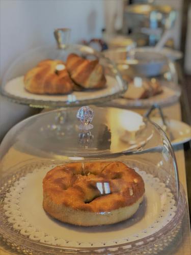 a bunch of pastries on plates on a table at Il Contado -room and breakfast- in Castelfranco Emilia