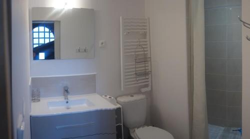 a white bathroom with a sink and a toilet at studio Eder Enea in Cambo-les-Bains