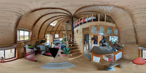 a large room with a building with a wooden ceiling at Domos Eva-Ray in Panguipulli