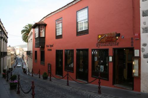 a red building on the side of a street at Hotel Rural Orotava in La Orotava