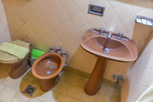 een badkamer met een wastafel en een toilet bij Hotel Puntarenas in Mar de Ajó