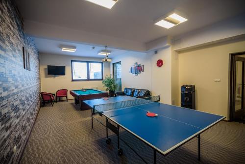 a conference room with two ping pong tables in it at Pensjonat pod Samowarem in Tylicz
