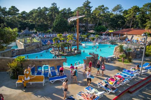 a group of people in a pool at a water park at Camping Village Le Vieux Port***** in Messanges