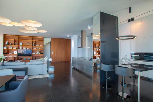 a kitchen and living room with a table and chairs at Olympic Residence Deluxe Apartments in Limassol
