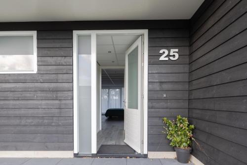 a door with the number on the side of a house at De Berkenhof Aparthotel in Nes