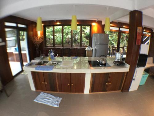 a kitchen with a large island in the middle at Kairos Villa in Seremban