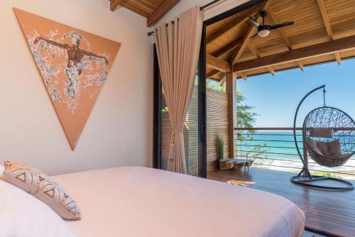 a bedroom with a bed and a large window at Vista del Alma Boutique - Adult Only in Santa Teresa Beach