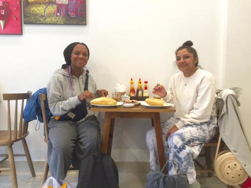 two women sitting at a table with food at candyinn in Hue