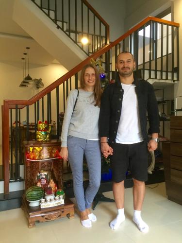 a man and a woman standing next to a staircase at candyinn in Hue