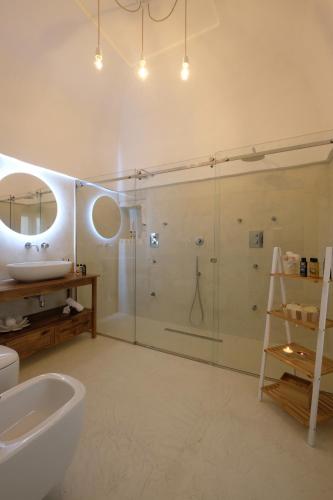 a bathroom with a shower and a sink and a mirror at Via Ricasoli 8 in Ostuni