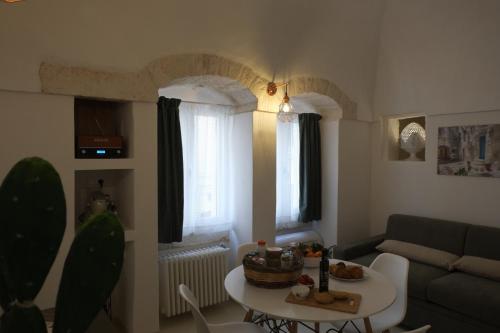a living room with a couch and a table at Via Ricasoli 8 in Ostuni