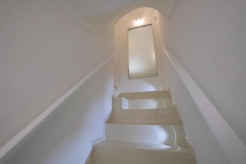 a stairway with a mirror on the wall at Via Ricasoli 8 in Ostuni