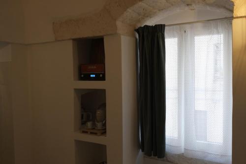 a room with a window with a black curtain at Via Ricasoli 8 in Ostuni