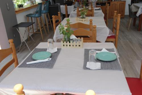 a table with green plates on top of it at Platoni Elite in Ialyssos