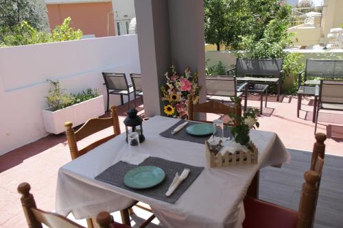 a table with a white table cloth on a patio at Platoni Elite in Ialyssos
