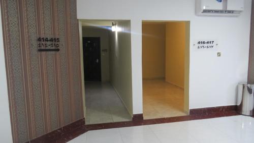 a mirror in a hallway in a building at Address hotel Apartments العنوان للشقق الفندقية in Aş Şa‘arah