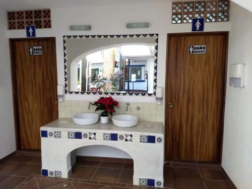 a bathroom with two sinks and a mirror at Hotel Hacienda Vallarta - Playa Las Glorias in Puerto Vallarta