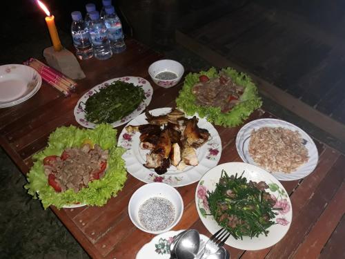 a table with plates of food on it at Kakrona Pouk Homestay in Siem Reap