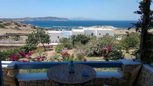 a table on a balcony with a view of the ocean at Stella's Home in Koufonisia
