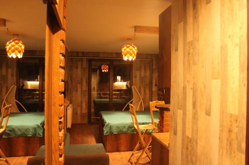 a room with two beds and two chairs in it at Love Journey Gudauri in Gudauri