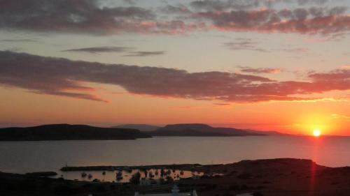 a sunset over a body of water at Stella's Home in Koufonisia