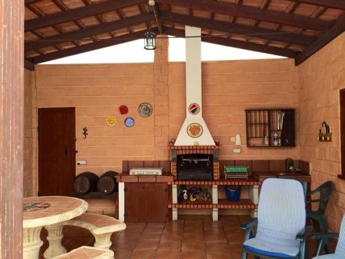 a kitchen with a stove and a table and chairs at CASA LA MOLINETA in Arafo