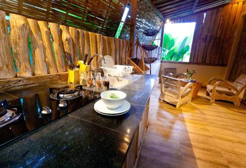 a kitchen with a counter with a bowl on it at Umah Tis Sebatu in Tegalalang