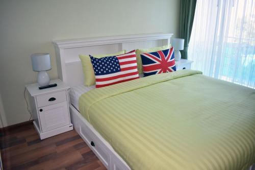 a bedroom with a bed with two american flags on it at My resort Huahin by D511 in Hua Hin
