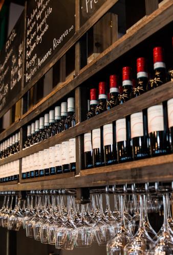 a bunch of wine bottles and glasses on a shelf at Mountain Lodge in Stöten