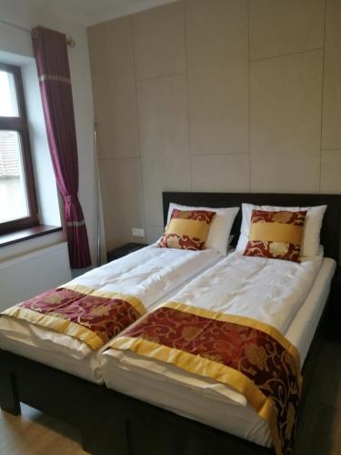 two beds sitting next to each other in a bedroom at Sun-House Pension&Restaurant -ParkingFree- in Prague