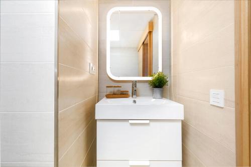 a bathroom with a white sink and a mirror at Apartamento Lujo Ancha del Carmen in Málaga