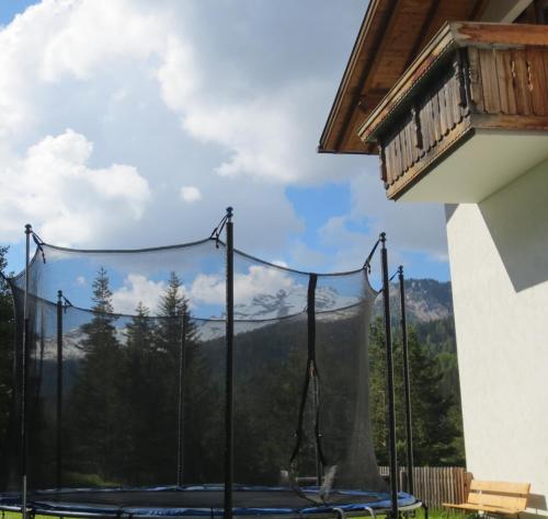 a swing set with a view of the mountains at Hotel Ciasa Ai Pini in San Cassiano