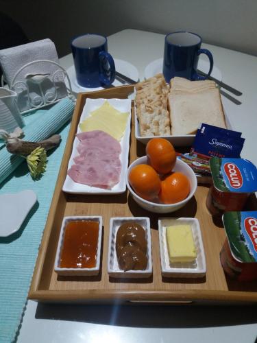 a tray with different types of food on a table at Eco Nautic Hostel in Valdivia