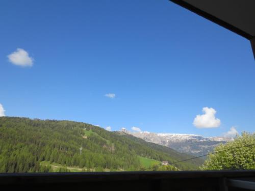 a view from a window of a mountain at Hotel Ciasa Ai Pini in San Cassiano